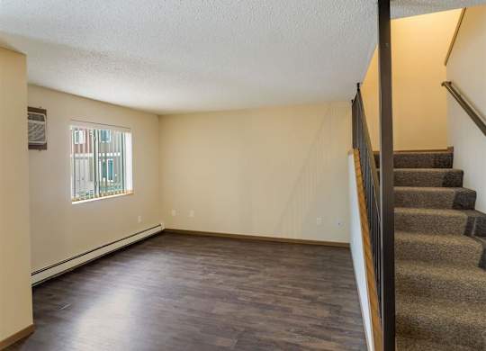 an empty living room with a staircase and a window  at Campus Park, Duluth, MN, 55811
