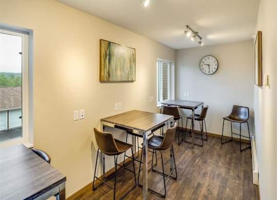 a dining room with tables and chairs and a clock at Campus Park, Duluth