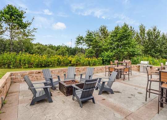 a patio with chairs and tables and a fire pit  at Campus Park, Duluth