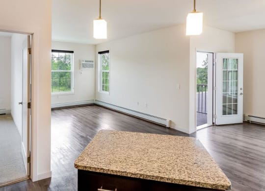 an empty living room with a table in the middle at Arbor Ridge, Forest Lake, MN