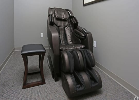 a massage chair and a stool in a room at Arbor Ridge, Forest Lake, 55025