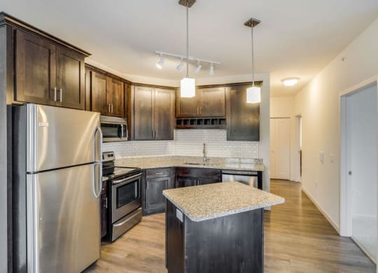 a kitchen with stainless steel appliances and wooden cabinets at Arbor Ridge, Forest Lake, MN, 55025