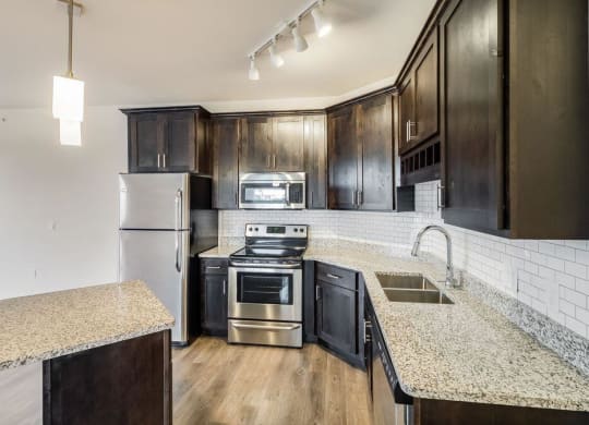 a kitchen with stainless steel appliances and granite counter tops at Arbor Ridge, Forest Lake, Minnesota