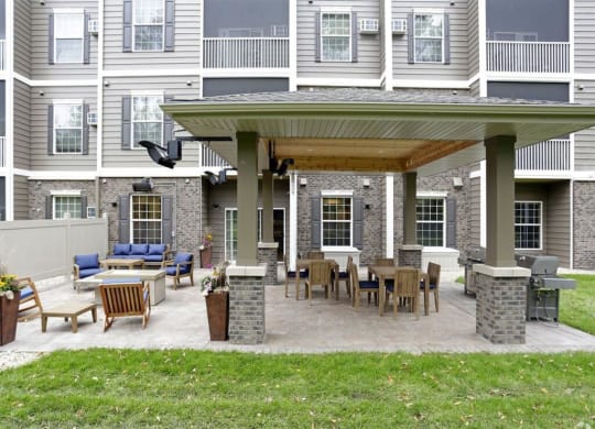 a covered patio with a table and chairs at Arbor Ridge, Forest Lake, Minnesota