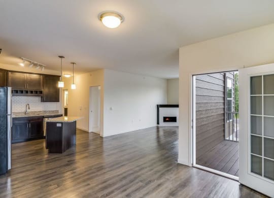 a living room and kitchen with a sliding glass door at Arbor Ridge, Forest Lake, Minnesota
