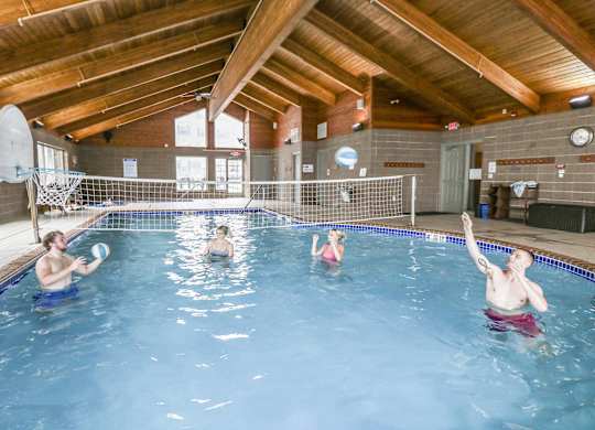 a group of people in a swimming pool playing with a frisbee at Campus Park, Duluth, 55811
