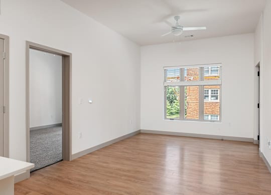 A room with a ceiling fan and a window with blinds.at Converge KC Uptown, Kansas City, MO