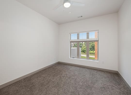 A room with a window and a fan on the ceiling.at Converge KC Uptown, Kansas City, MO 64111
