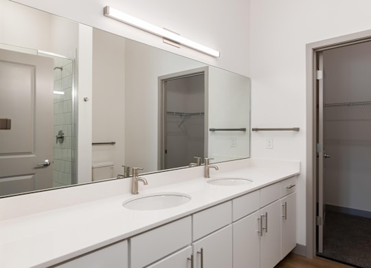 A bathroom with a white counter top and a sink.at Converge KC Uptown, Missouri, 64111