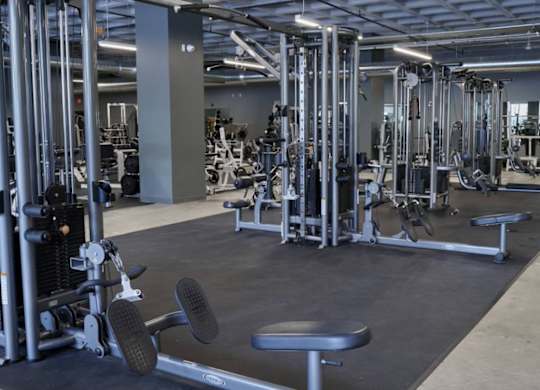 A gym with a variety of equipment including weights and benches.at Converge KC Uptown, Missouri, 64111