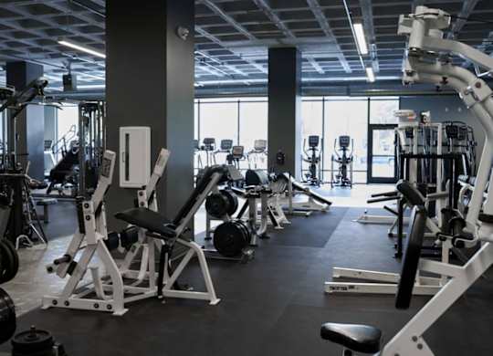 A gym with a variety of equipment including weights and weight machines.at Converge KC Uptown, Kansas City, MO