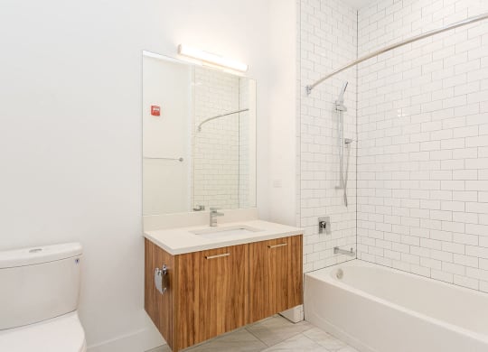 a white bathroom with a toilet sink and shower