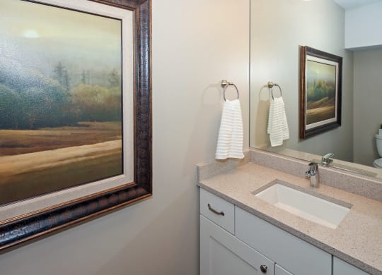 the second bathroom has a large mirror and a sink