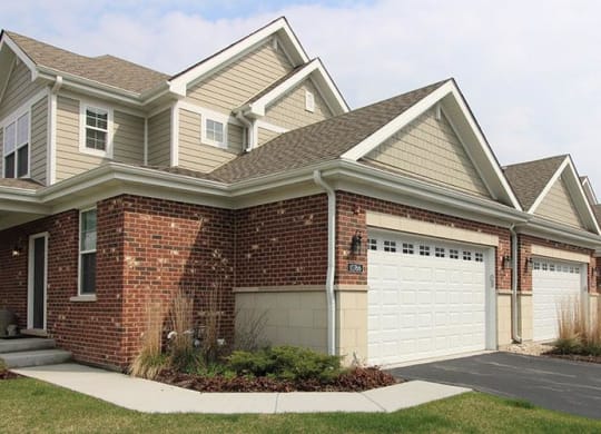 a brick house with a white garage door at Countryside Townhomes, Countryside Illinois