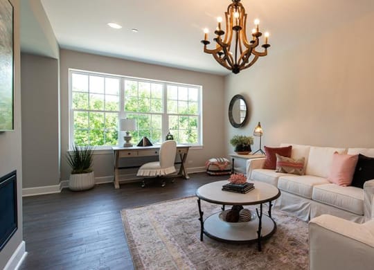 a living room with a white couch and a table at Countryside Townhomes, Countryside, IL