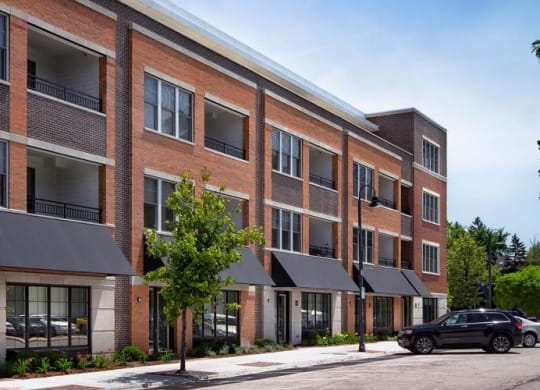 a large brick building with cars parked in front of it at Clarendon Hills 229, Clarendon, IL