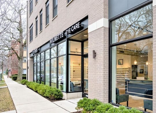 the front of a building with a glass facade and a sidewalk at Wilmette 1121, Wilmette, Illinois