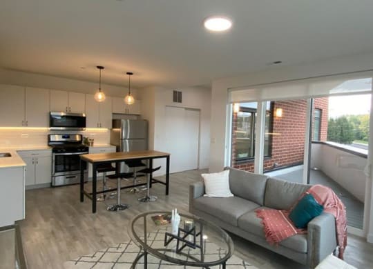 a living room and kitchen with a couch and a table at Highwood 546, Highwood, 60040