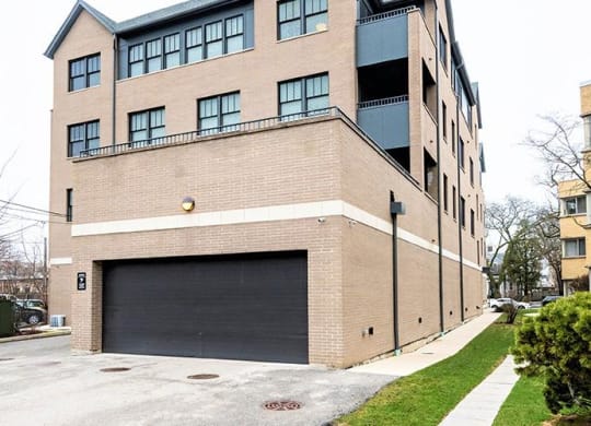 a large brick building with a garage door at Wilmette 1121, Wilmette, IL