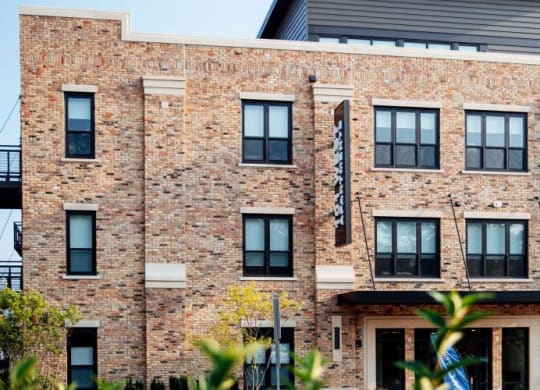 a large brick building with a flag on the front at Barrington 101, Barrington, IL