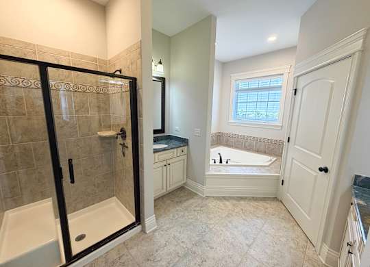A bathroom with a walk-in shower and a bathtub.