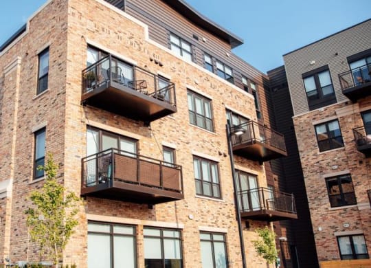 a brick apartment building with balconies at Barrington 101, Barrington Illinois