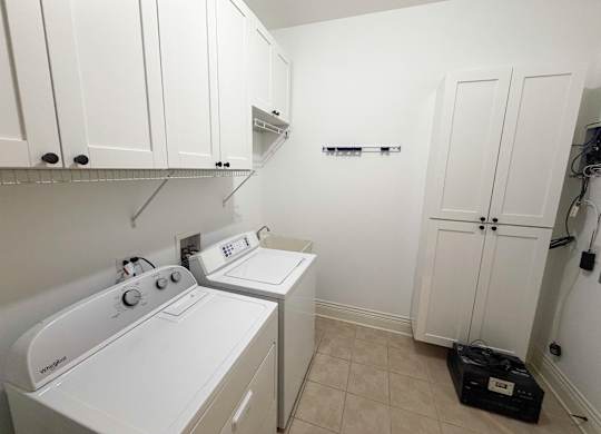 A small laundry room with a washer and dryer.