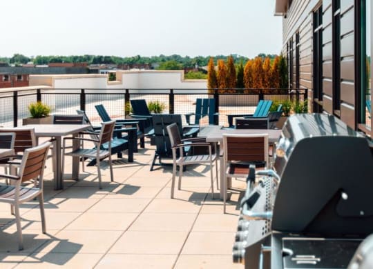 a patio with tables and chairs on the roof of a building at Barrington 101, Barrington, IL 60010