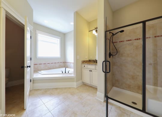 a bathroom with a shower and a tub and a sink