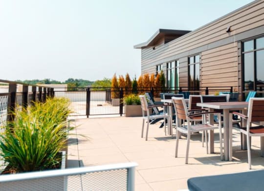 a patio with tables and chairs on a roof at Barrington 101, Illinois, 60010