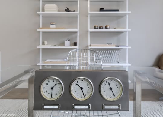 three clocks on a table in a living room at Clarendon Hills 229, Clarendon