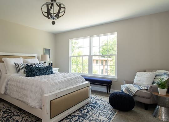 a bedroom with a bed and a window at Countryside Townhomes, Countryside