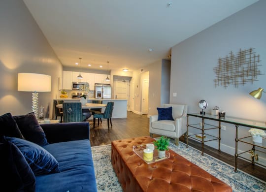 a living room with a couch and a coffee table and a kitchen at Barrington 101, Barrington Illinois