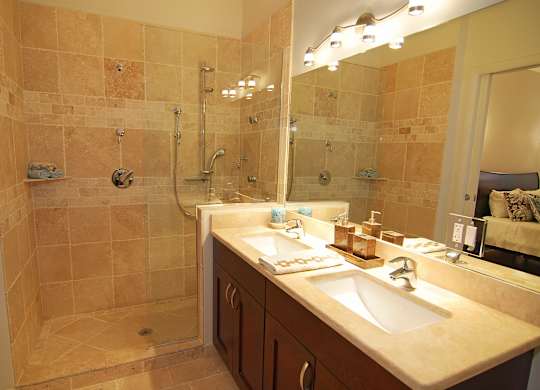 a bathroom with two sinks and a shower