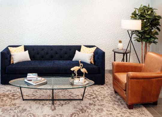 a living room with a blue couch and a glass table at Barrington 101, Chicago