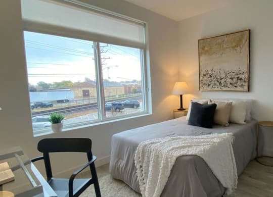 a living room with a table and a large window at Highwood 546, Highwood, IL