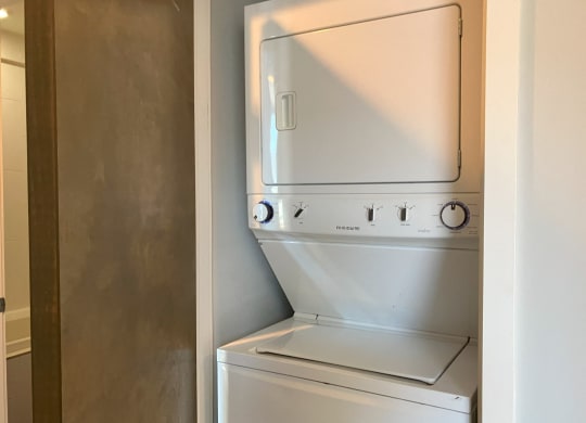 an empty laundry room with a washer and dryer