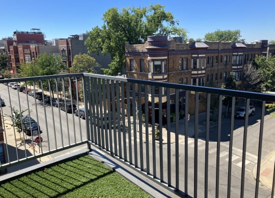 a balcony with a view of a city street and buildings