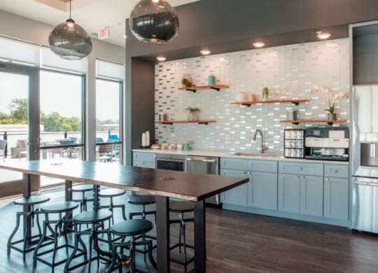 a kitchen with a bar and a stainless steel refrigerator at Barrington 101, Barrington, IL