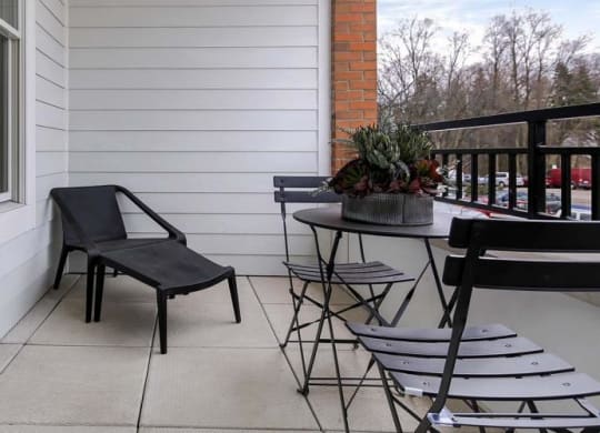 a balcony with a table and chairs and a window at Clarendon Hills 229, Clarendon