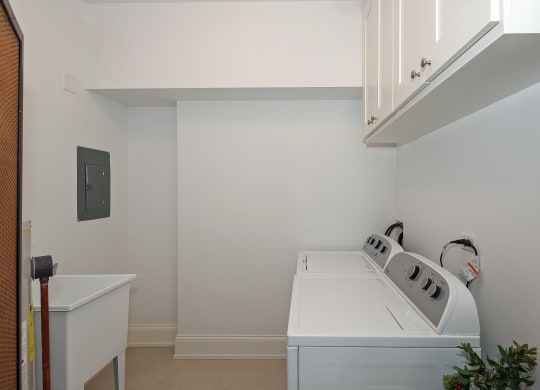 a laundry room with a washer and dryer and a sink