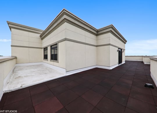 a large roof terrace with a blue sky in the background