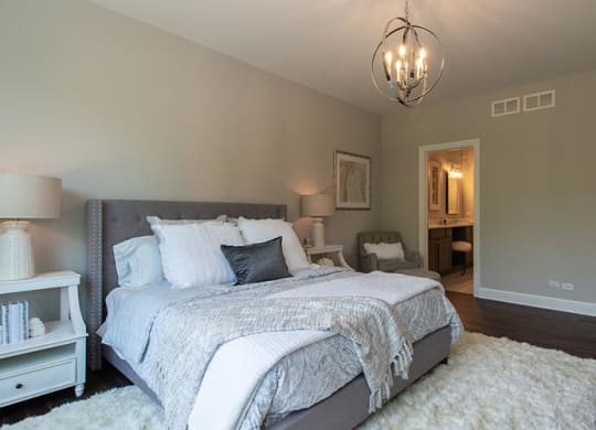 a bedroom with a bed and a white rug at Countryside Townhomes, Countryside