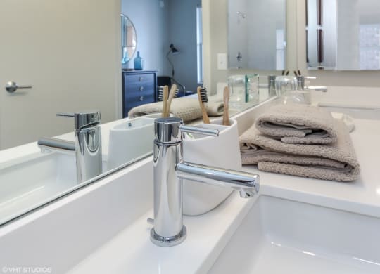 a bathroom with a sink and a mirror and towels at Clarendon Hills 229, Clarendon Illinois