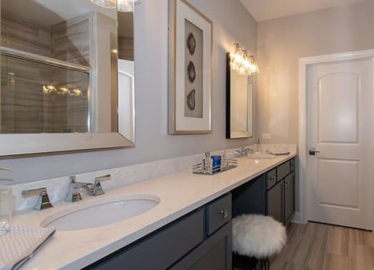 a bathroom with two sinks and a mirror at Countryside Townhomes, Illinois, 60525