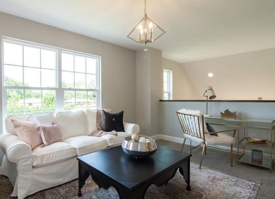 a living room with a white couch and a table at Countryside Townhomes, Countryside Illinois