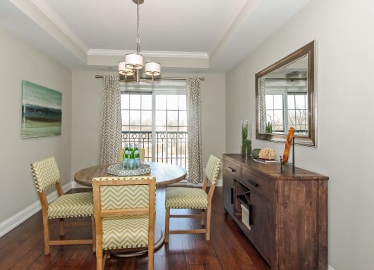 a dining room with a table and chairs and a window