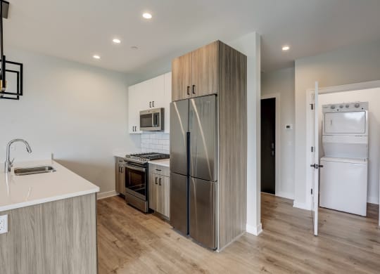 a kitchen with stainless steel appliances and a refrigerator