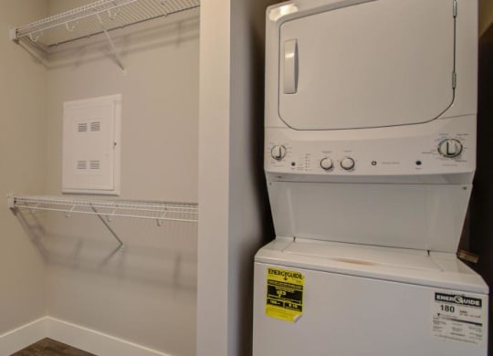 a white washer and dryer in a room next to a bedroom at Barrington 101, Illinois, 60010