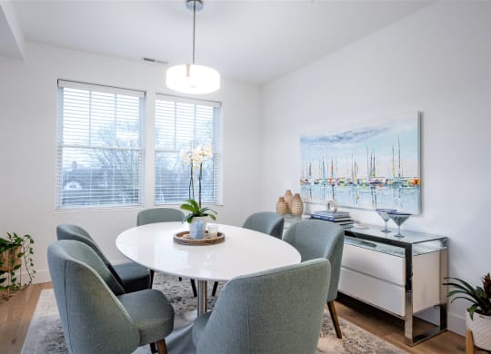 a dining room with a white table and chairs